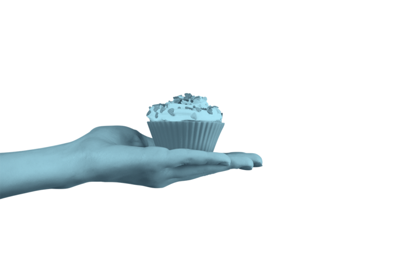 hand extending a sprinkled cupcake